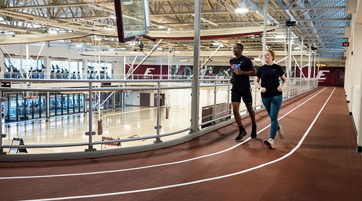 students run on the indoor track