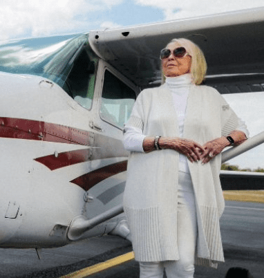 Photo of Wilma "Willie" Walker standing but an aircraft.