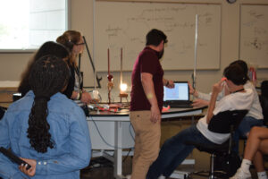 Dr. Jason Fry helps STEM campers complete a physics experiment