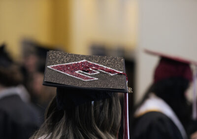 a mortar board decorated with a power E in glitter