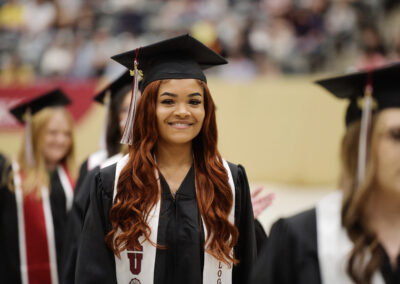 a student smiles during the commencement ceremony procession
