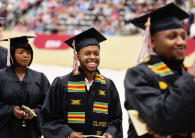a student smiles during the commencement ceremony procession
