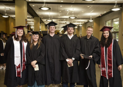 students pose together during commencement