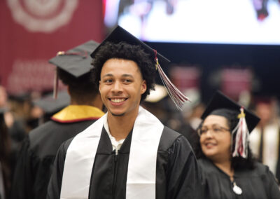 a student smiles during their commencement ceremony