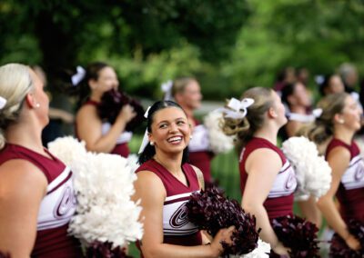 cheerleaders smile as they perform