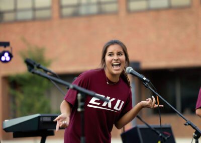 a student talks into a microphone at the Powell Palooza