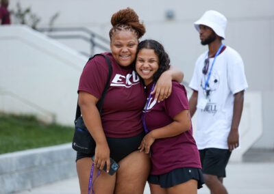 two students wearing EKU shirts smile at the camera