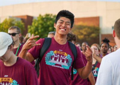 a smiling student wears a Big E Welcome shirt