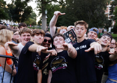 A group of male EKU students pose in the crowd awaiting outdoor Flo Rida concert