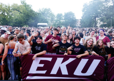 large group of EKU students smile, eagerly awaiting the start of the outdoor Flo Rida concert