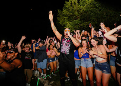 While rapping, Flo Rida joins the crowd of excited EKU students with hands raised in the Ravine at the night time concert