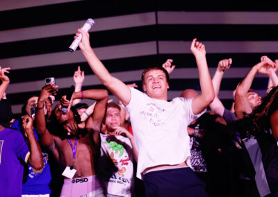 Young man celebrates and dances on stage at Flo Rida concert