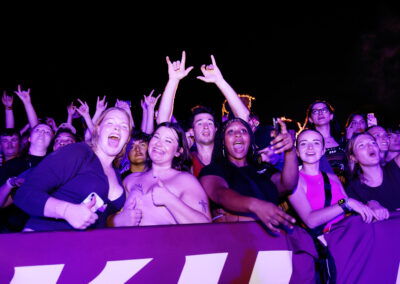 Excited female students celebrate front row and Flo Rida concert