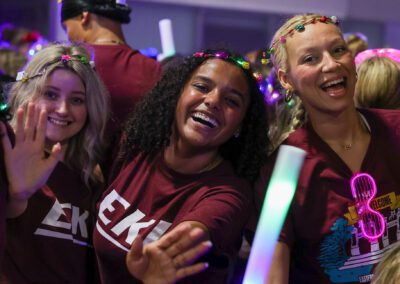 three students smile during the Big E Bash