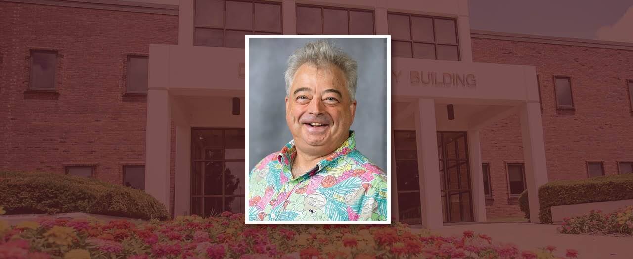 Dr. D. Gary Brown, wearing a colorful pastel Hawaiian shirt.