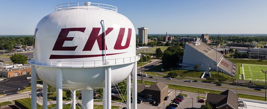 A high elevation view of EKU's campus, with the logoed water tower in the foreground