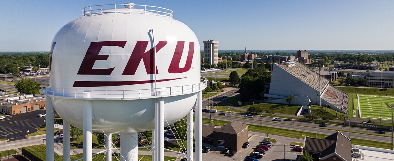 A high elevation view of EKU's campus, with the logoed water tower in the foreground