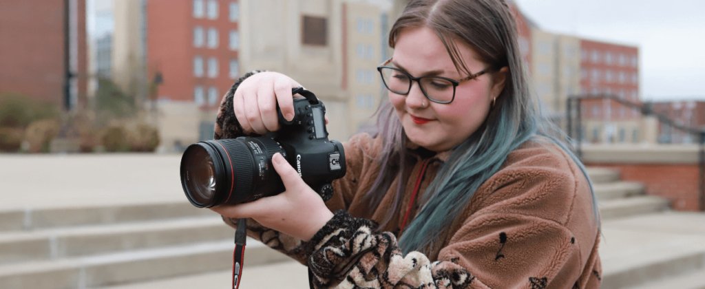 Close up of EKU student Emma Watson as she takes a photo outside on campus.