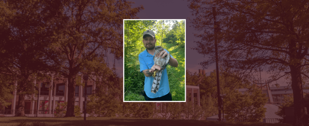 EKU graduate assistant, Joshua Castle, holds a hawk.