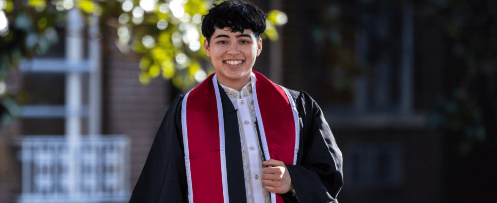 EKU Fall commencement speaker, Mackenzie Maawac wearing graduation regalia and smiling.