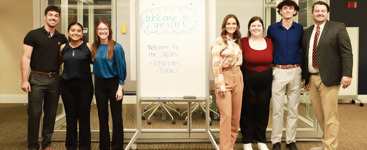 Six EKU undergraduate students in EKU's Faculty and Teaching Learning Center with Dr. James Blair after presenting their business ideas.