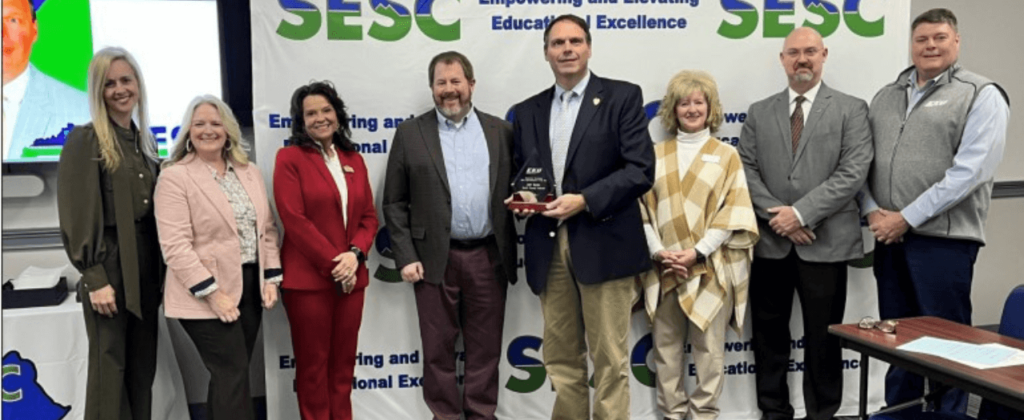 A group of EKU faculty award Jeff Saylor as the "Experience Excellence" Superintendent of the Year."