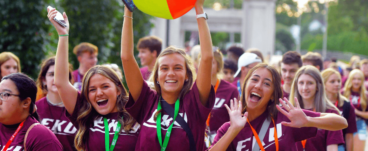 A large group of excited students, wearing EKU t-shirts celebrate as they walk in Big E Welcome.