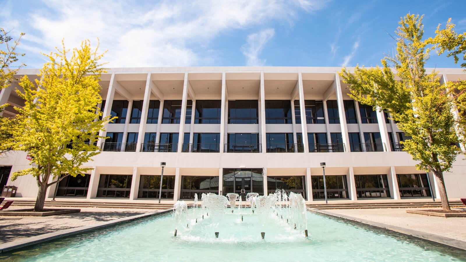 fountains shoot water into the pool outside the Powell Building