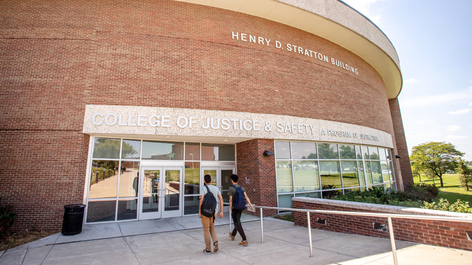 students walk toward the entrance to the College of Justice, Safety, and Military Science in the Henry D. Stratton Building