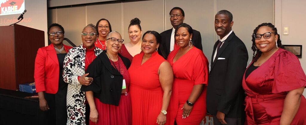 A group of EKU faculty and staff, dressed in red and black, attend the 4oth annual KABHE conference.