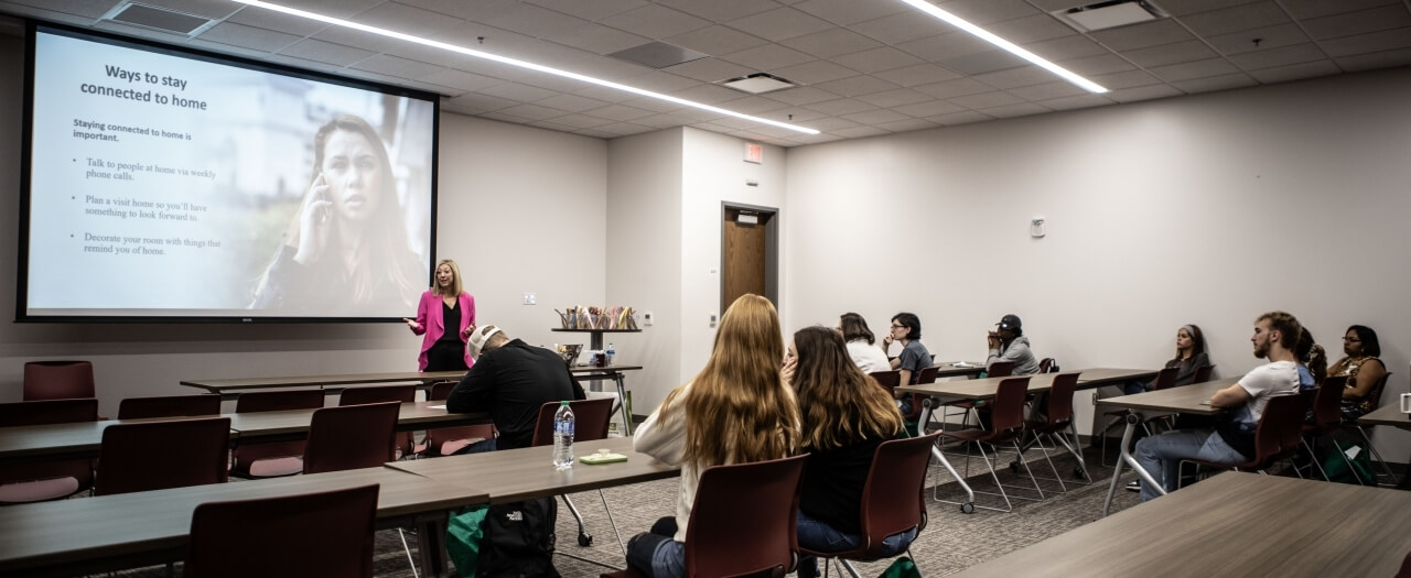 Students in a classroom are listening to a session at the Gen 1 conference.