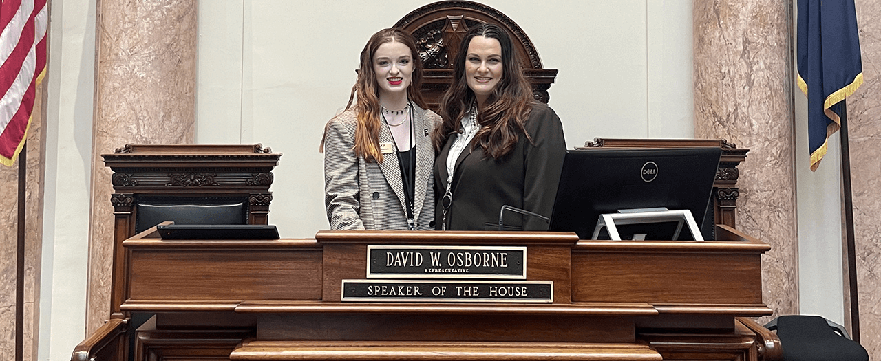 EKU student Rylee Meachum and State Representative and EKU graduate Ashley Tacket Laferty stand in the House of Representatives in the Kentucky State capitol.