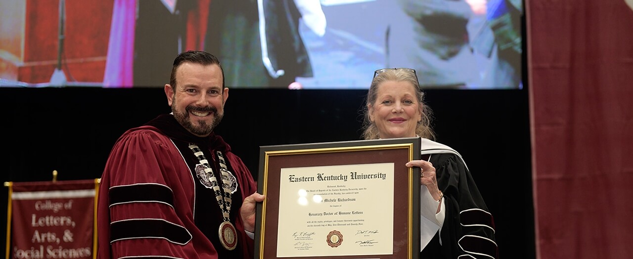 EKU President David McFaddin presents author Kim Michele Richardson with an Honorary Doctorate degree at graduation.