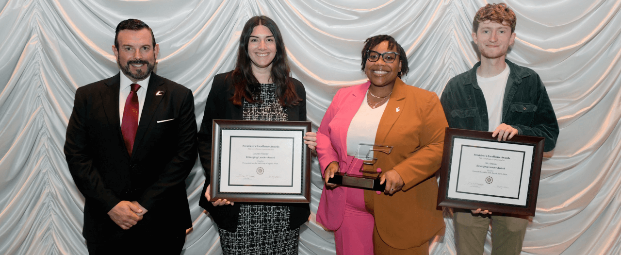 EKU President David McFaddin stands with three award winners at the recognition ceremony.