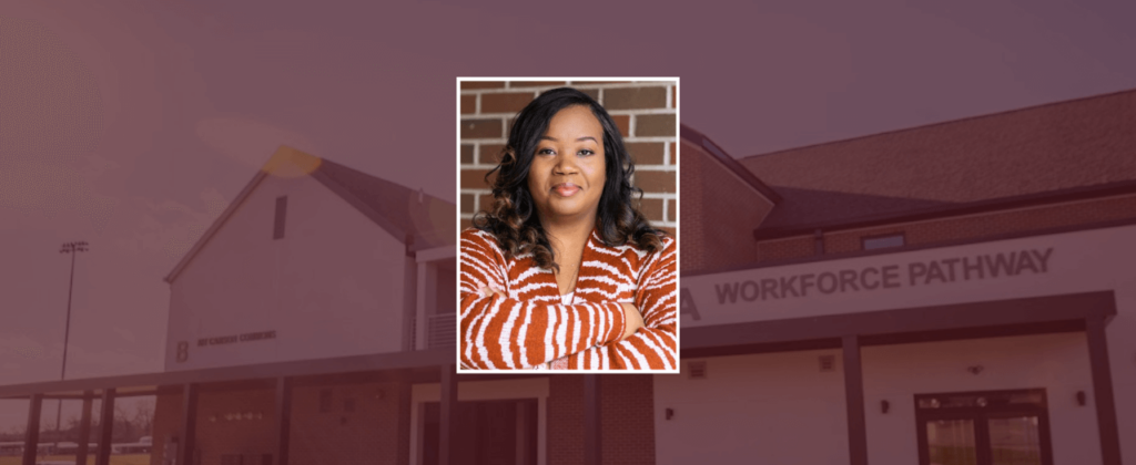 Dominique Kellam smiles for a photo in front of EKU's Workforce Pathway at Kit Carson Commons building.