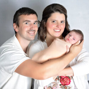 EKU student Whitney Cox poses in white on a white background with her family