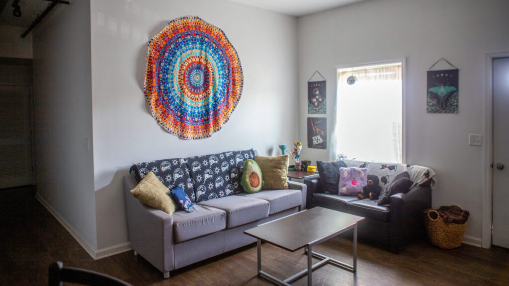 the living room in a Grand Campus apartment with a couch and loveseat and coffee table