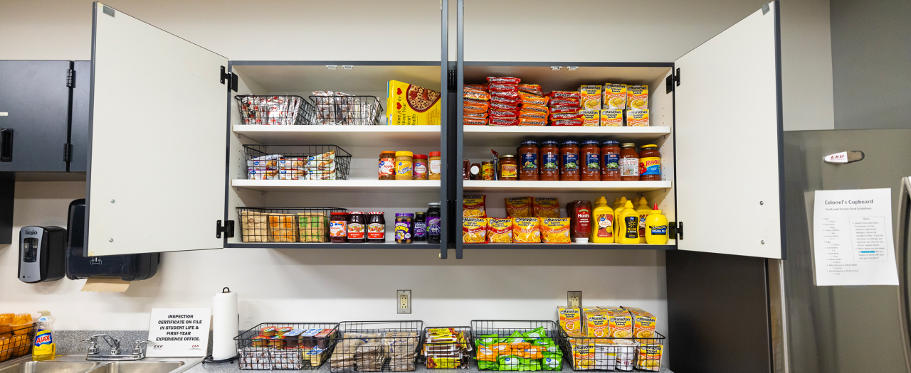 Open doors to a cupboard show a full rang of meal supplies available to EKU students.