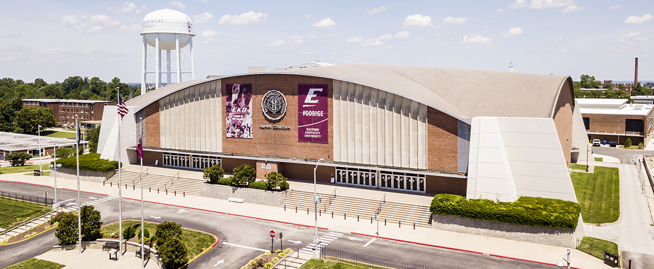 EKU's Alumni Coliseum, from an aerial view with blue sky and clouds in the background