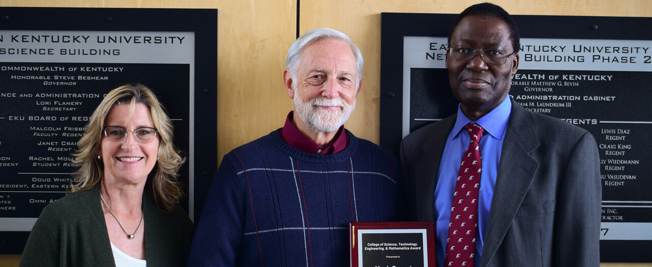 Photo of Mark Sweet alongside Dean Sherry Harrel and Dean Tom Otieno